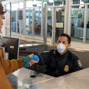 US Customs and Border Protection Officer wearing face mask